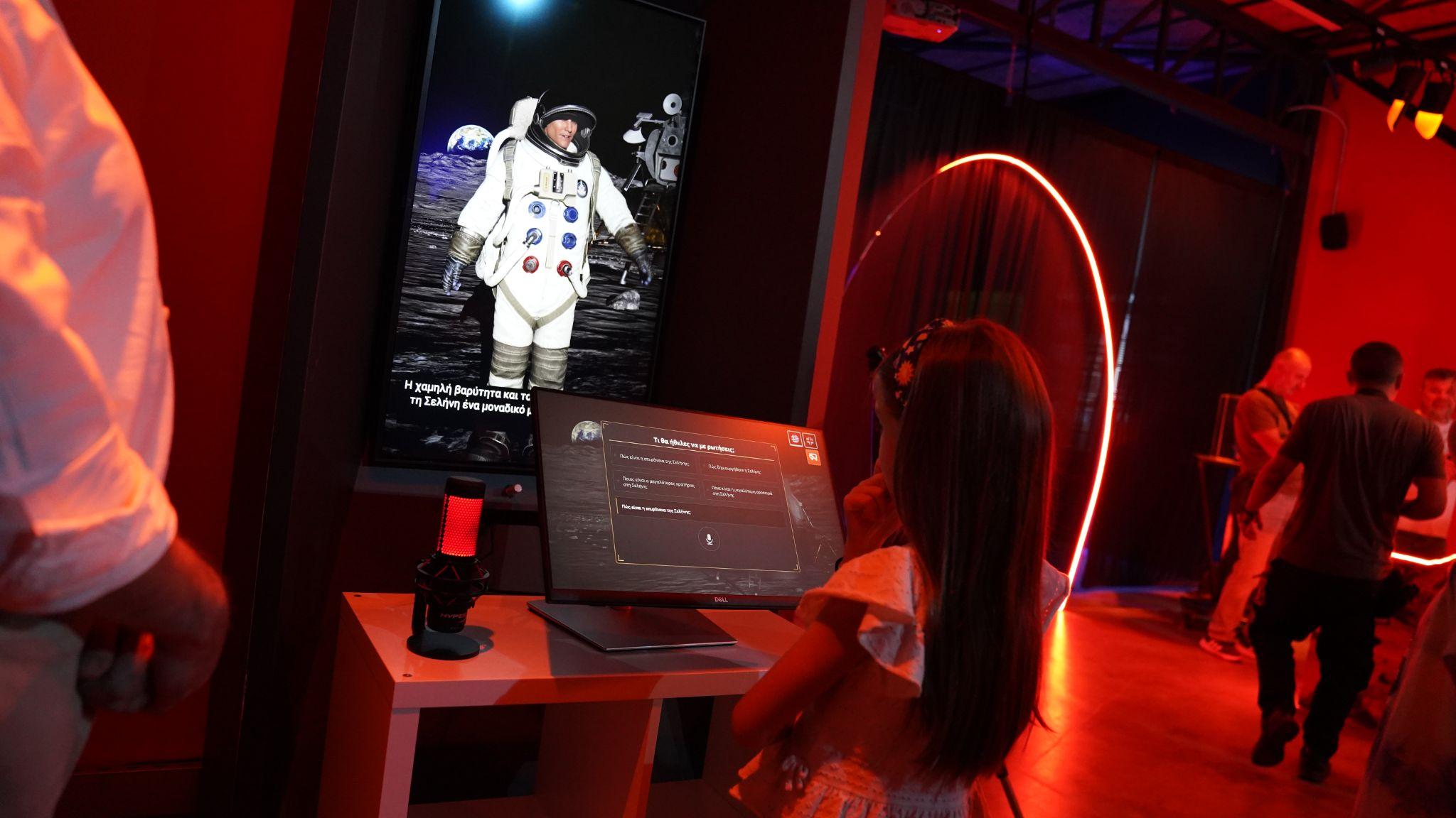 A visitor using the astronaut avatar and touch screen at JOIST in Larisa