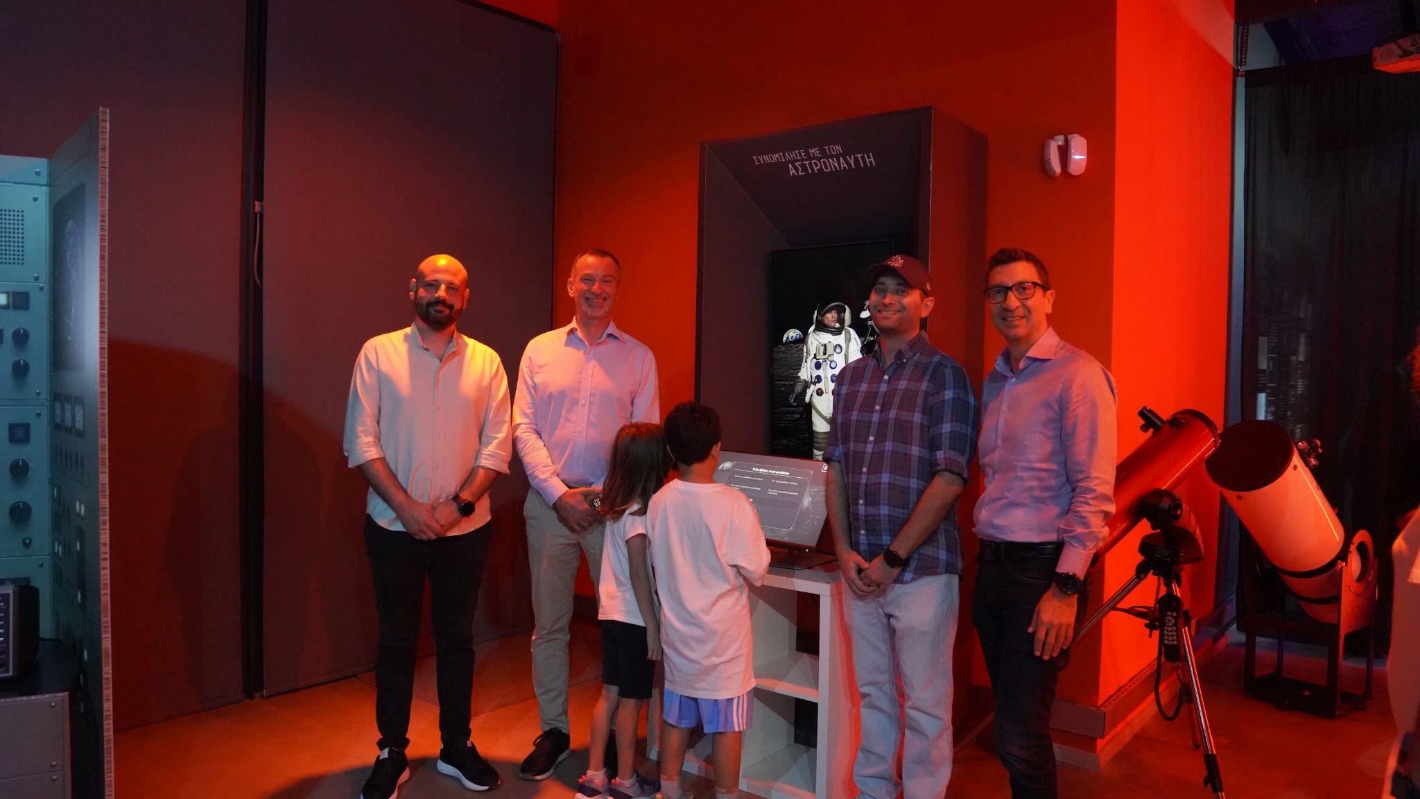 Visitors and presenters beside the astronaut avatar installation at JOIST in Larisa
